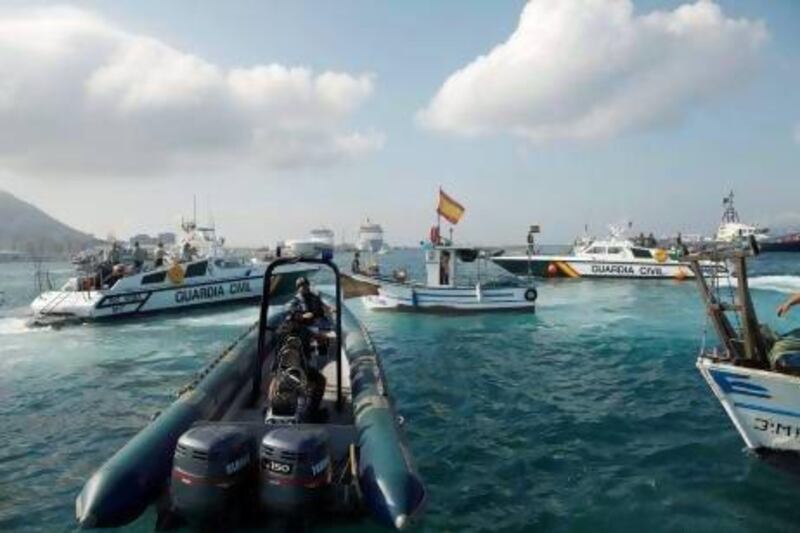 Spanish Civil Guard boats surround a fishing boat during a protest at the site where an artificial reef was built in Algeciras bay, La Linea de la Concepcion.