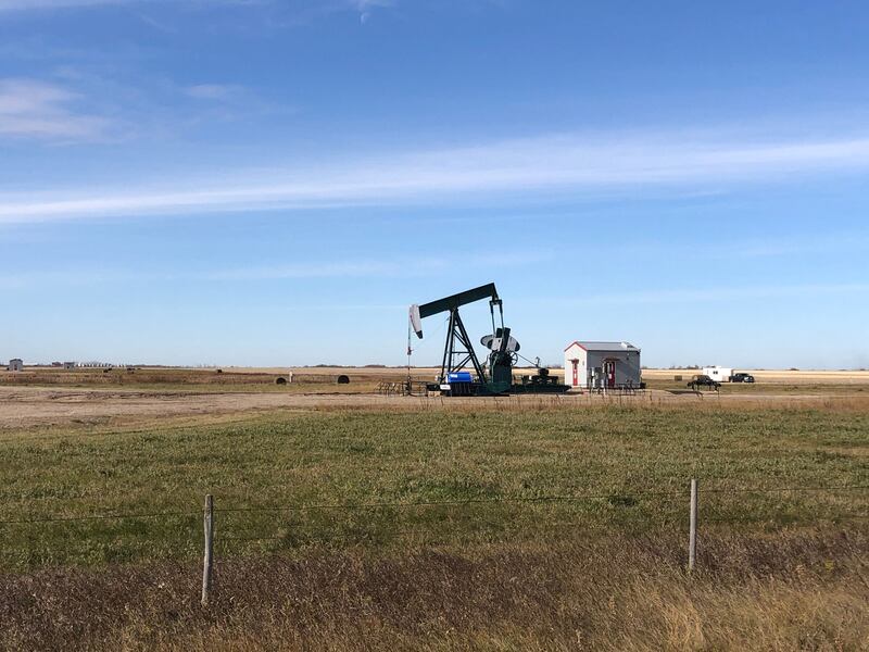 An oil pump jack in Stoughton, Canada. Goldman Sachs has reduced its oil price forecasts, citing stronger-than-expected supply and weak demand. AFP