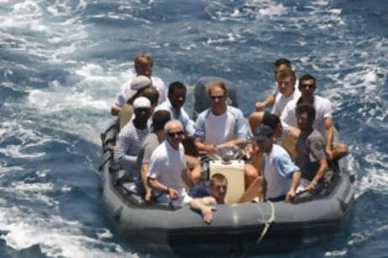 Crew members of Le Ponant sail towards a French frigate after Andrew Mwangura helped negotiate their release.
