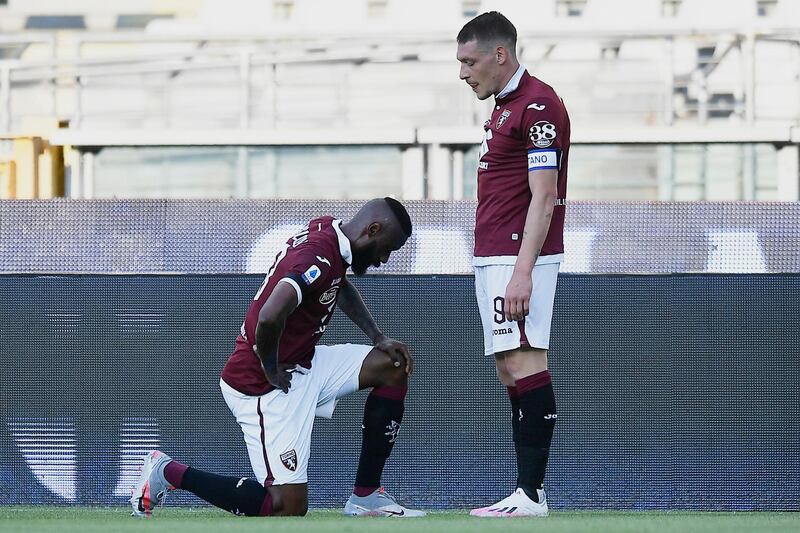 Torino's Nicolas Nkoulou, left, kneels next to teammate Andrea Belotti after scoring his side's opening goal. AP Photo