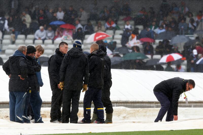 Ground staff stand by the pitch cover as rain delays the start of ICC Champions Trophy final cricket match between England and India at Edgbaston cricket ground in Birmingham, England, Sunday, June 23, 2013. (AP Photo/Sang Tan)  *** Local Caption ***  Britain Cricket ICC Trophy Final England India.JPEG-0fd71.jpg