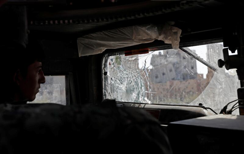 A member of Syrian Democratic Forces drives an armoured fighting vehicle past destroyed buildings in Raqqa, Syria September 30, 2017. REUTERS/Erik De Castro