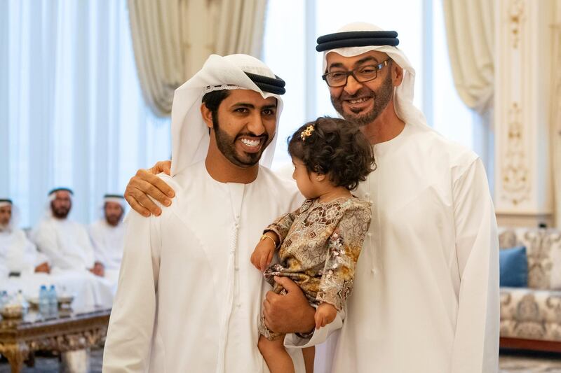 ABU DHABI, UNITED ARAB EMIRATES - October 21, 2019: HH Sheikh Mohamed bin Zayed Al Nahyan, Crown Prince of Abu Dhabi and Deputy Supreme Commander of the UAE Armed Forces (L), stands for a photograph with family members who received "Amntk Bladk" token, during a Sea Palace barza.

( Mohamed Al Hammadi / Ministry of Presidential Affairs )
---