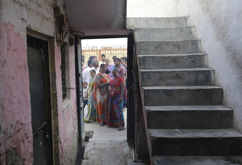 Residents of the area gather outside the house of a two-year-old girl who was abducted and raped by two men in West Delhi on October 16, 2015. Rajat Gupta / EPA