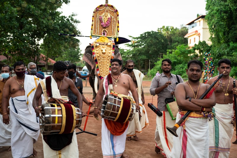 Percussion artists playing the thavil, a traditional drum, walk ahead of a caparisoned elephant carrying an idol of a deity during Onam, at the Vamana Hindu temple in Kochi, Kerala. AP