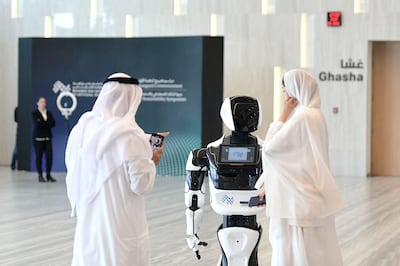 Guests entertained by a robot at Mohamed bin Zayed University of Artificial Intelligence in Abu Dhabi. Khushnum Bhandari / The National 