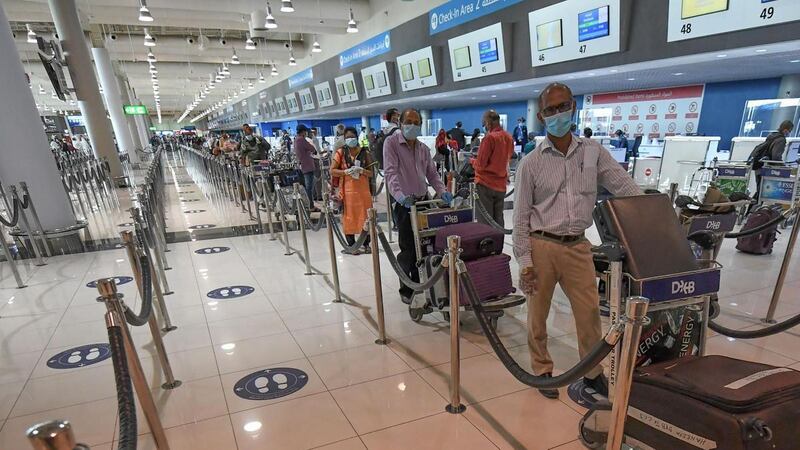 Indian nationals queue to check in at the Dubai International Airport to board a repatriation flight in July 2020. AFP