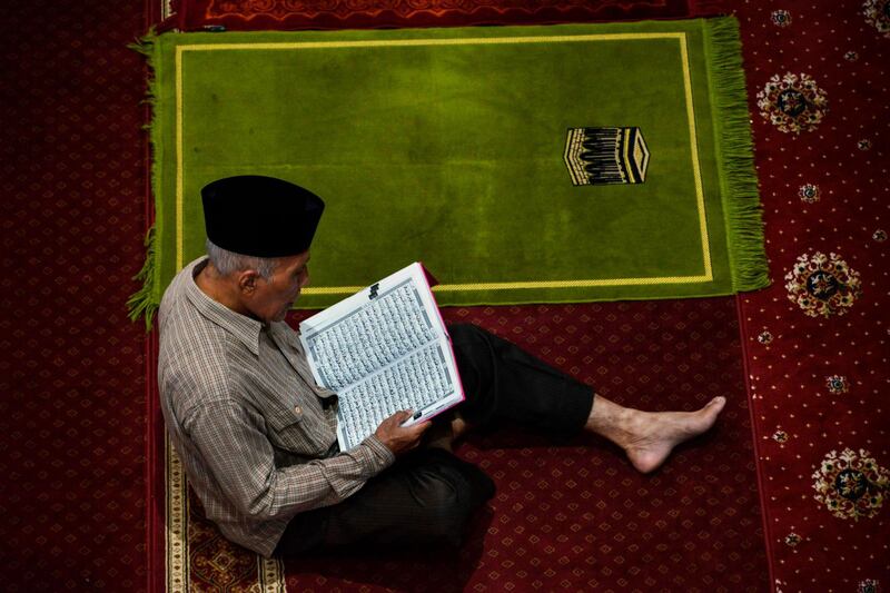 An Indonesian reads the Quran at the Al Makmur mosque in Banda Aceh.  AFP