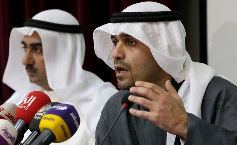 Kuwaiti minister of finance and minister of oil, Anas Al Saleh speaks during a press conference for Kuwait's financial and economic reform plan as , as the minister of commerce and industry, Yousef Mohammed Al Ali. left, looks on. Yasser Al Zayyat / AFP