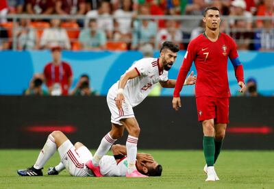 Soccer Football - World Cup - Group B - Iran vs Portugal - Mordovia Arena, Saransk, Russia - June 25, 2018   Portugal's Cristiano Ronaldo as Iran's Ramin Rezaeian and Morteza Pouraliganji react before a red card decision was referred to VAR   REUTERS/Matthew Childs