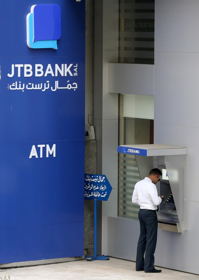 A man uses an ATM outside Jammal Trust Bank (JTB) branch in Ashrafieh, Lebanon, August 30, 2019. REUTERS/Mohamed Azakir