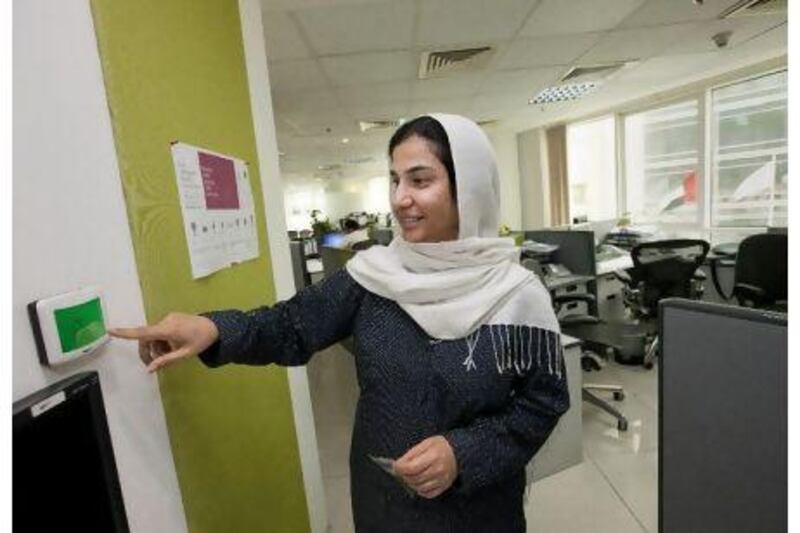 Farhana Imran of Archcorp shows a thermostat in her company's office. By mandating a temperature a little higher than the setting in most offices, the architectural engineering firm has cut its electricity bill. Jaime Puebla / The National
