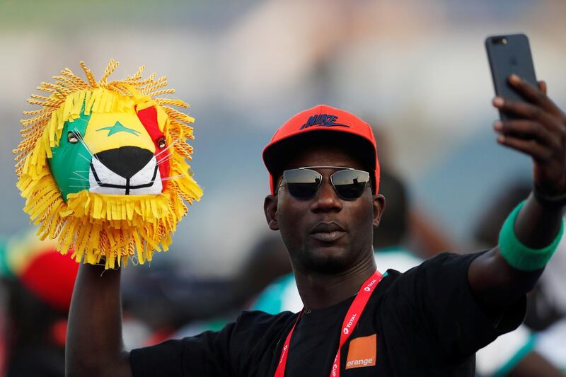 General view of a Senegal fan holding a handmade lion's head at the 30 June Stadium in Cairo. Reuters