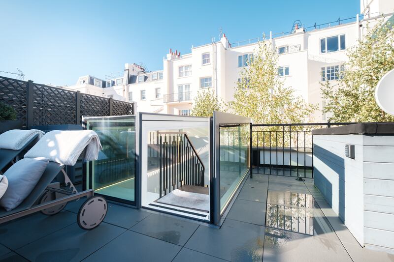 A custom-built and mechanised roof opening provides access to the 620 sq ft roof terrace