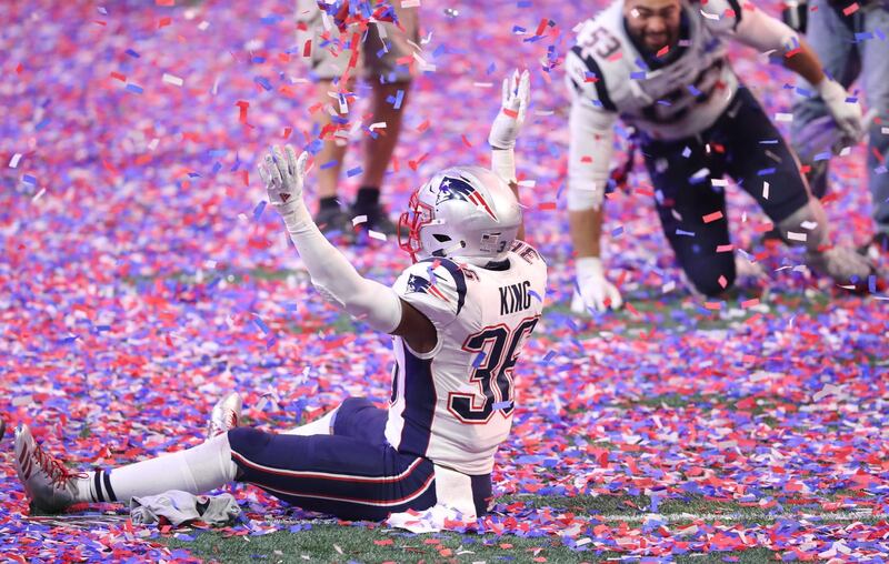 Patriots linebacker Brandon King sits in confetti as he celebrates. USA Today Sports