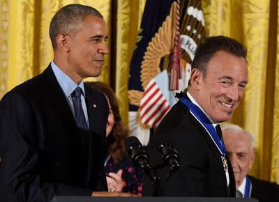 (FILES) In this file photo taken on November 22, 2016, US President Barack Obama looks on after presenting musician Bruce Springsteen with the Presidential Medal of Freedom, the nation's highest civilian honor, during a ceremony honoring 21 recipients, in the East Room of the White House in Washington, DC. Streaming giant Spotify on Febuary 22, 2021 unveiled a new show featuring two American cultural heavyweights: rock star Bruce Springsteen and former US president Barack Obama. / AFP / SAUL LOEB
