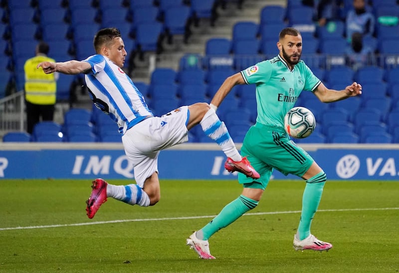 Real Madrid's Karim Benzema in action with Real Sociedad's Andoni Gorosabel. Reuters
