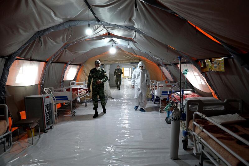 Iranian army soldiers work in a temporary 2,000-bed hospital for COVID-19 coronavirus patients set up by the army at the international exhibition center in northern Tehran, Iran. AP Photo