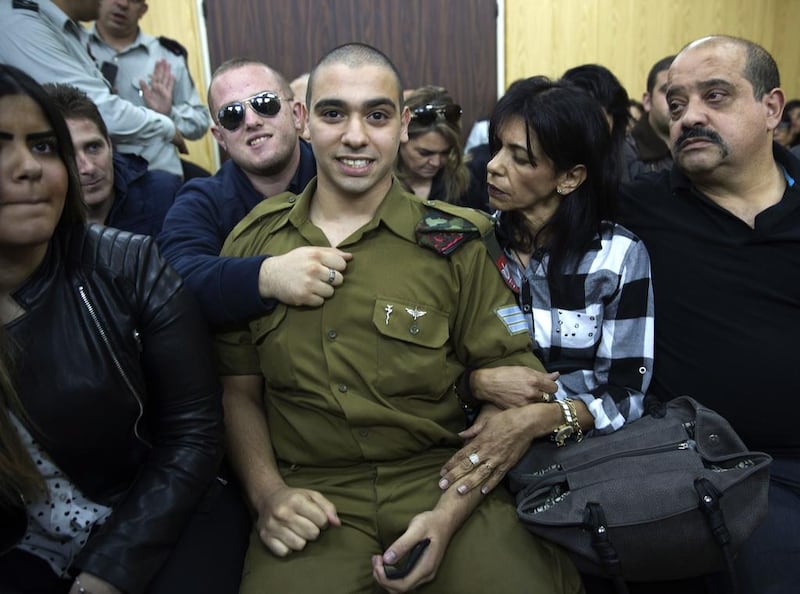 Israeli solider Elor Azaria waits with his parents for the verdict inside the military court in Tel Aviv, this month. Heidi Levine / Pool via AP Photo