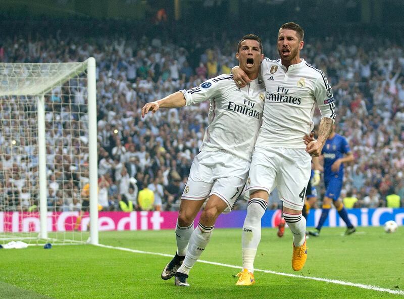 MADRID, SPAIN - MAY 13:  (L-R) Cristiano Ronaldo of Real Madrid celebrates with teammate Sergio Ramos of Real Madrid after scoring the opening goal from the penalty spot during the UEFA Champions League Semi Final, second leg match between Real Madrid and Juventus at Estadio Santiago Bernabeu on May 13, 2015 in Madrid, Spain.  (Photo by Gonzalo Arroyo Moreno/Getty Images)