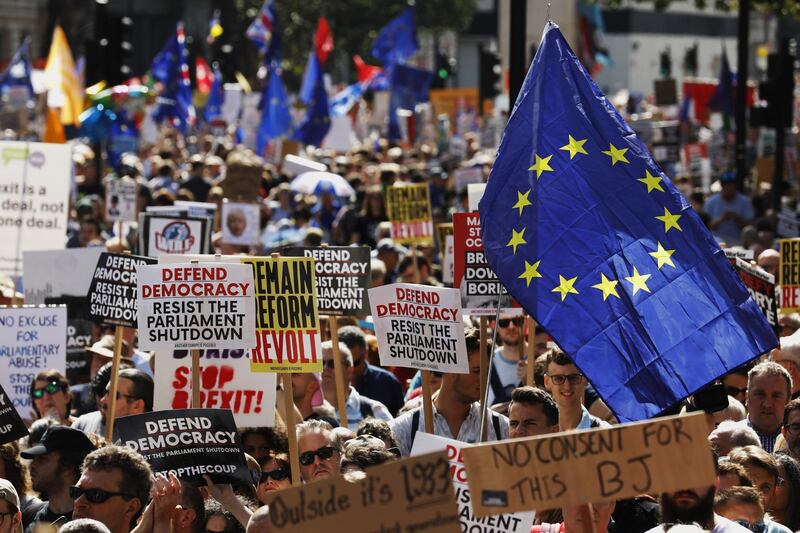 Demonstrators wave European Union (EU) flags and hold placards outside Downing Street during a protest against the proroguing of parliament, in London, U.K., on Saturday, Aug. 31, 2019. Prime Minister Boris Johnson asked Queen Elizabeth II on Aug. 28 to prorogue the House of Commons, as the suspension is known in parliamentary jargon, from Sept. 12 until the Queen’s Speech on Oct. 14. Photographer: Luke MacGregor/Bloomberg