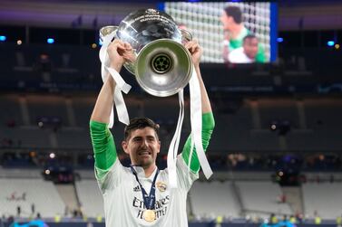 Real Madrid's goalkeeper Thibaut Courtois holds the trophy after the Champions League final soccer match between Liverpool and Real Madrid at the Stade de France in Saint Denis near Paris, Saturday, May 28, 2022.  (AP Photo / Frank Augstein)