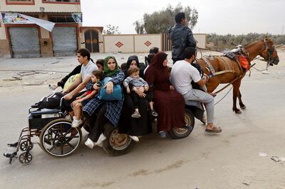 Palestinians fleeing northern Gaza on a horse-drawn cart. Reuters