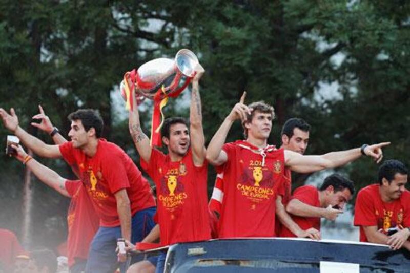 Cesc Fabregas leads the celebrations with the European Championship trophy after Spain's return to Madrid.