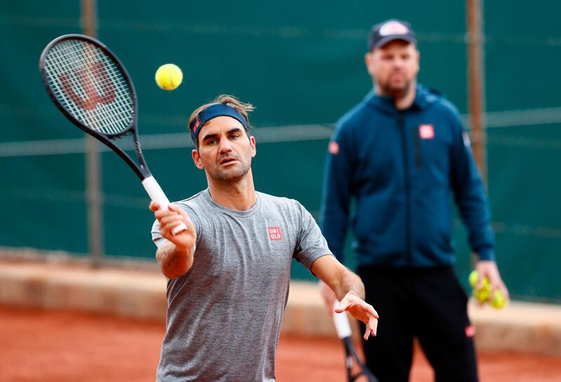 Roger Federer and coach Severin Luethi during training at the Tennis Club de Geneve. Reuters