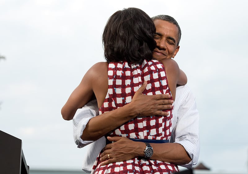 Mr Obama hugs his wife after she introduces him at a grassroots campaign event at Lagomarcino's Confectionary in Davenport, Iowa, August 15, 2012. Photo: The National Archives