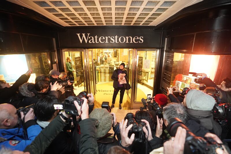 Caroline Lennon, the first customer to purchase a copy of Spare, poses for photographers at Waterstones in Piccadilly, London. PA