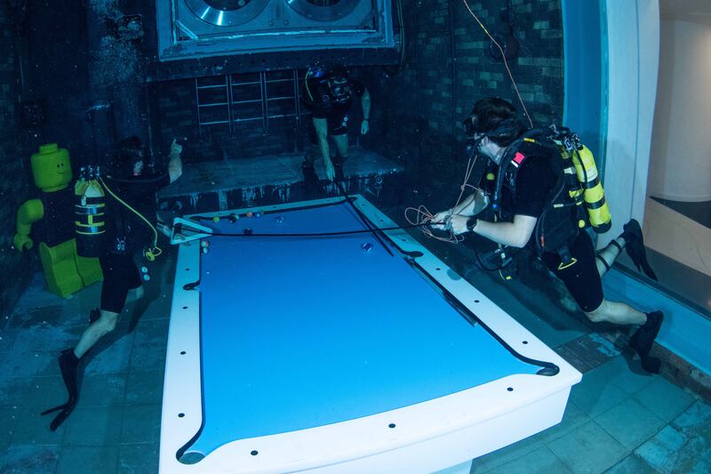 Royal Navy ship divers try out the new Deep Dive Dubai pool.