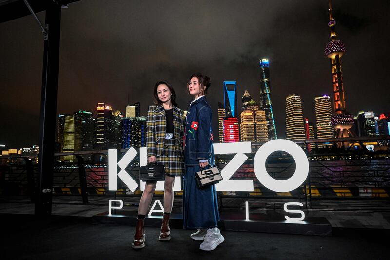 From left: Hong Kong singers Gillian Chung and Charlene Choi pose on the red carpet ahead of the Kenzo fashion show at the North Bund Bay in Shanghai. All photos: AFP 