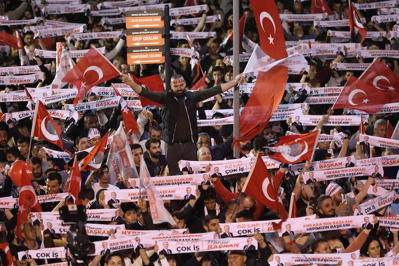 Supporters of Mr Yavas listen to his victory speech in Ankara, Turkey. AFP