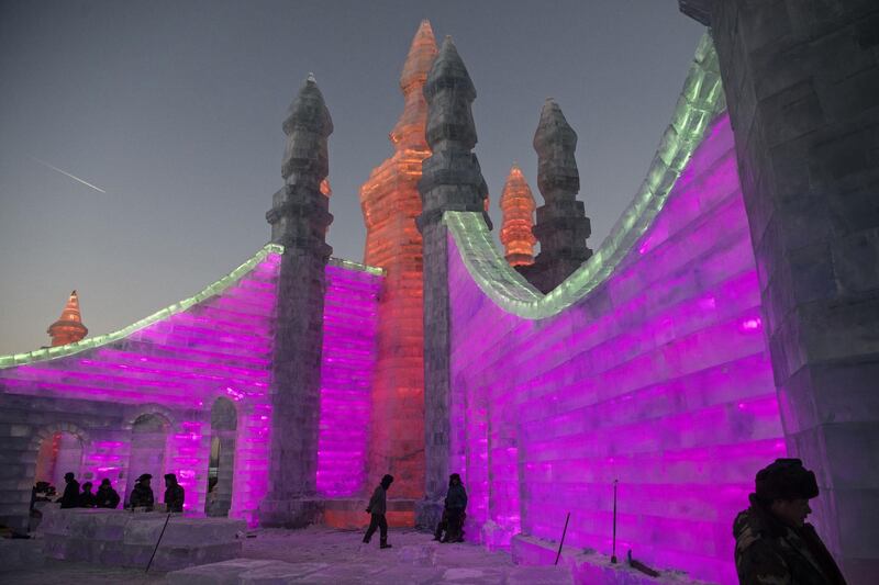 Chinese labourers work to finish large ice sculptures in preparation for the Harbin Ice and Snow Festival in Harbin. Getty Images