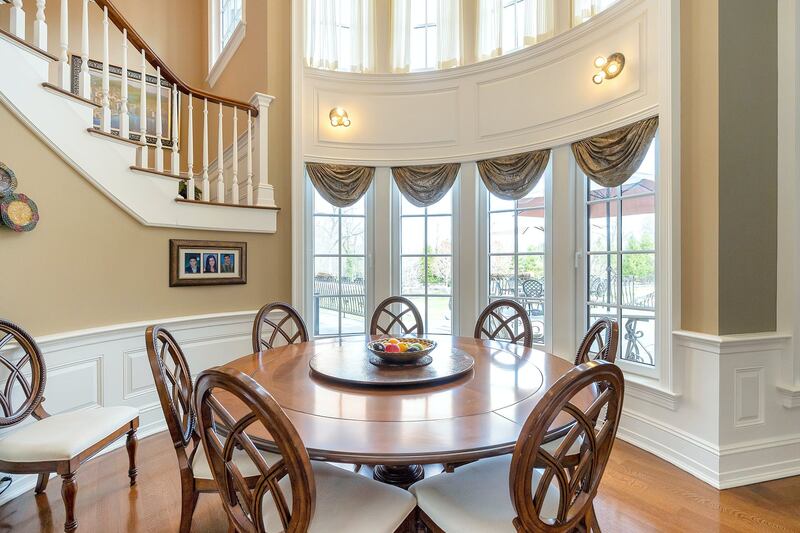 Sweeping staircases add to the grandeur. Courtesy Douglas Elliman Realty