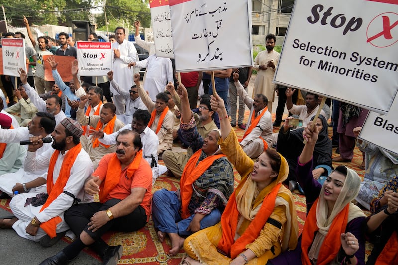 Members of Christian groups and others demonstrate in Lahore to condemn the attack on Christian areas. AP