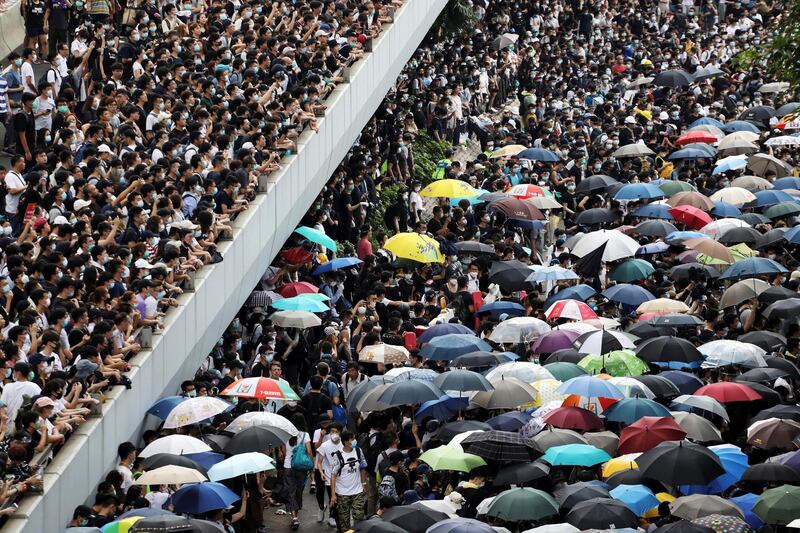 Protesters march along a road demonstrating against a proposed extradition bill in Hong Kong, China. Reuters