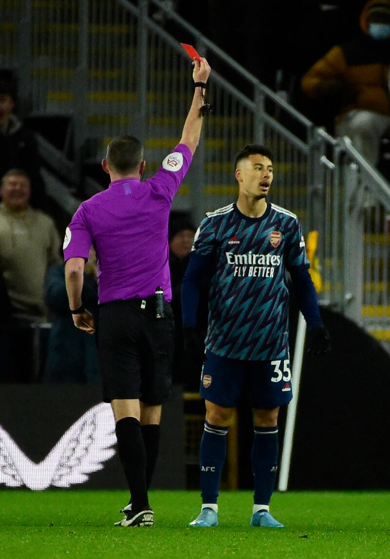 Arsenal's Gabriel Martinelli is shown a red card by referee Michael Oliver. Reuters