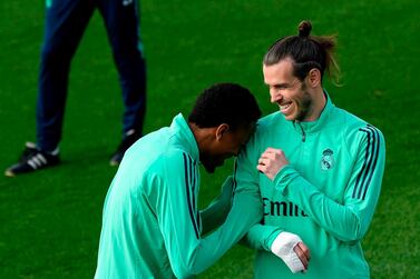Real Madrid forward Gareth Bale and Brazilian defender Eder Militao joke during their training session. AFP