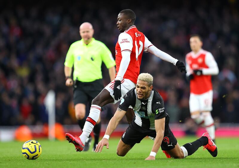 LONDON, ENGLAND - FEBRUARY 16: Joelinton of Newcastle United is tackled by Nicolas Pepe of Arsenal during the Premier League match between Arsenal FC and Newcastle United at Emirates Stadium on February 16, 2020 in London, United Kingdom. (Photo by Richard Heathcote/Getty Images)
