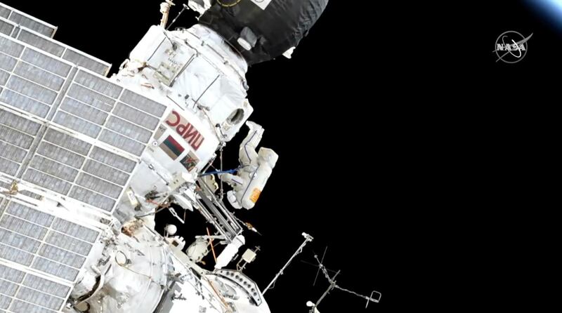 In this image made from video provided by NASA, Expedition 59 Commander Oleg Kononenko, center, participates in a spacewalk outside the International Space Station with Flight Engineer Alexey Ovchinin, obscured, on Wednesday, May 29, 2019. (NASA via AP)