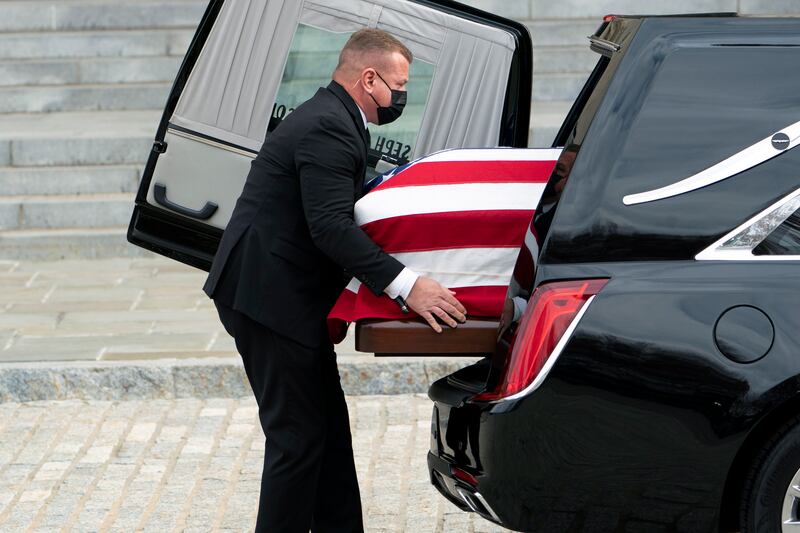 The flag-draped casket is moved from the hearse at the Washington National Cathedral for a funeral service. AP