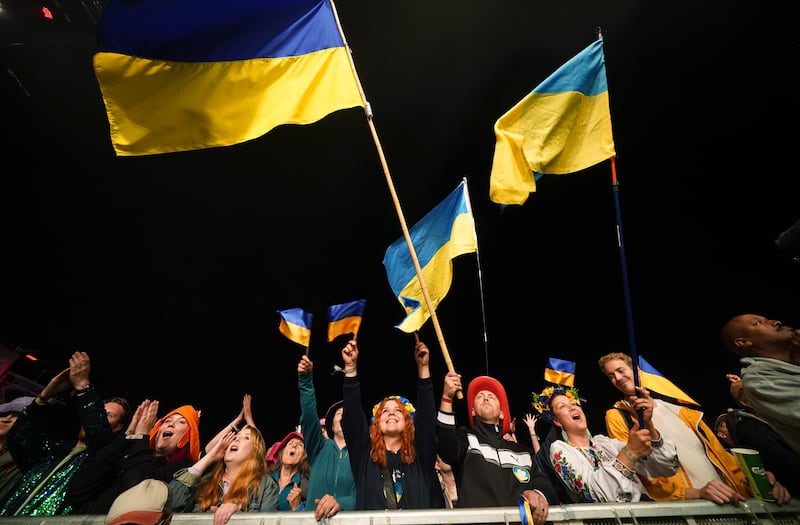 Crowds wave the Ukrainian flag as they watching Kalush Orchestra perform. EPA