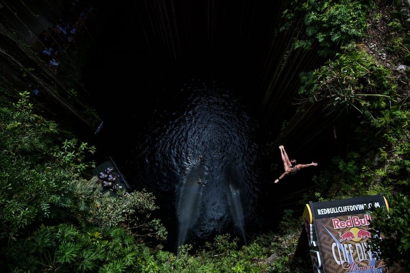 A cliff diver leaps 26 metres down into the Ik Kil cenote in Yucatan, Mexico. Getty Images