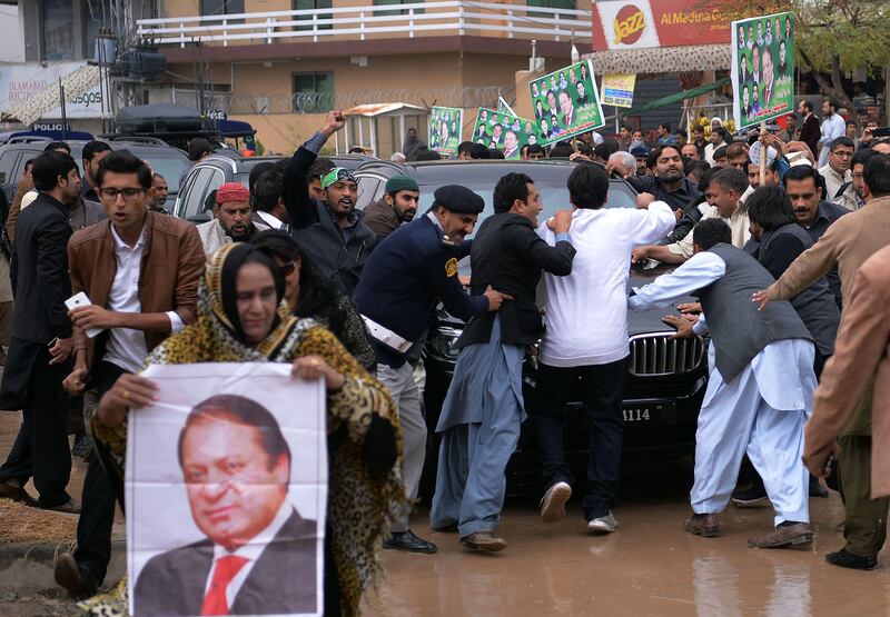 Supporters of ousted Pakistani prime minister Nawaz Sharif surround Sharif's car as he arrives to appear before an accountability court to face corruption charges in Islamabad. Aamir Qureshi / AFP Photo