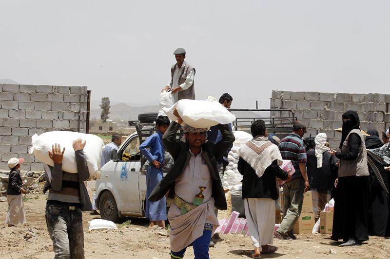 epa06723014 Conflict-affected Yemenis receive their families' food supplies provided by Mona Relief Yemen at a neighborhood in Sana'a, Yemen, 09 May 2018. According to reports, the ongoing conflict in Yemen has created the worst humanitarian crisis in the world, where some 75 percent of Yemen's 26-million population are in need of humanitarian assistance, facing acute food insecurity, including 11.3 million children who cannot survive without it.  EPA/YAHYA ARHAB