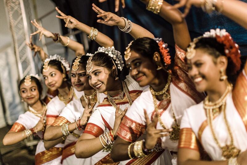 A group of colourful classical dancers from the Kumari Shiksha Dance Institution pose backstage before taking part during the two day Diwali (Festival of Lights) Hindu festival celebrations at the old Drive-Inn in Durban, on October 19, 2019. AFP