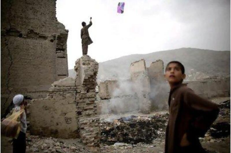 Kite flying in Afghanistan is a form of sport that many have taken to the level of art. Above, a boy flies a kite from the remains of a building in the capital.