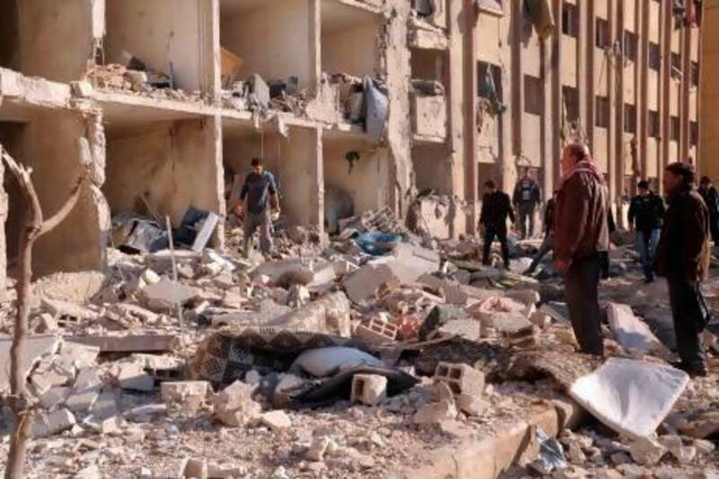 Syrians gather at the scene of an explosion outside Aleppo University, between the university dormitories and the architecture faculty.